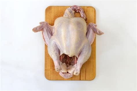 Premium Photo | The preparation of raw turkey for cooking thanksgiving day