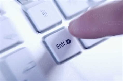 Young woman pressing key on keyboard, close up stock photo