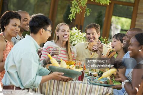 Family Eating Together Outdoors High-Res Stock Photo - Getty Images