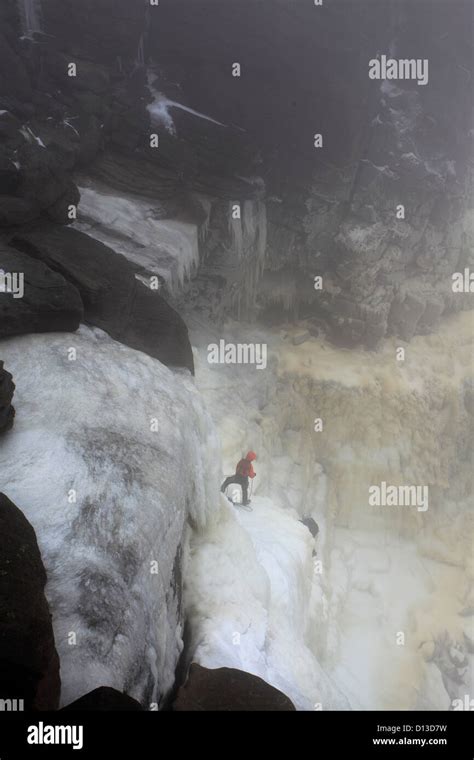 Ice climbers on the frozen Kinder Downfall waterfall, Wintertime, Kinder Scout, Peak District ...