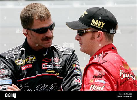 Dale Earnhardt Jr. (R) talks to his brother Kerry Earnhardt on pit row ...