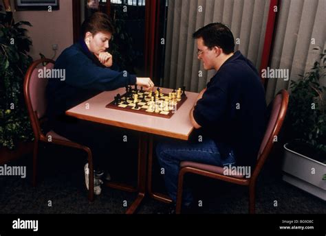 Man and woman playing chess Stock Photo - Alamy