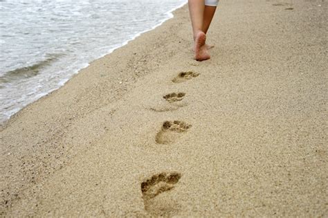 Premium Photo | Foot prints on the beach sand