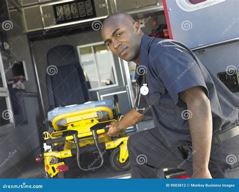 Paramedic Removing Gurney from Ambulance Stock Photo - Image of horizontal, crew: 9003812