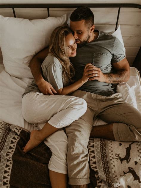 a man and woman laying in bed together