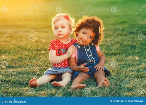 White Caucasian and Latin Hispanic Babies Hugging Outside in Park ...