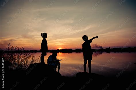 silhouette children playing happy time at sunset Stock Photo | Adobe Stock