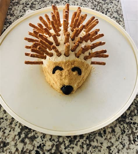 a white plate topped with a pastry shaped like a hedgehog