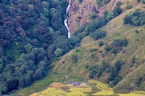 Premium Photo | A waterfall is on the side of a hill in the mountains.