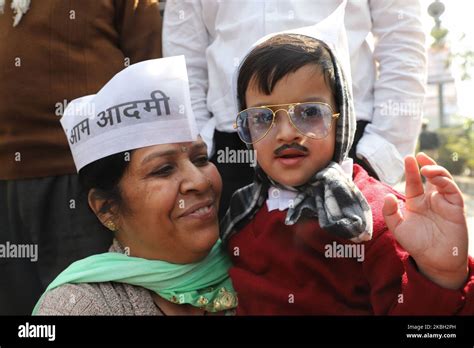 A boy dressed as Delhi Chief Minister Arvind Kejriwal during Swearing ...