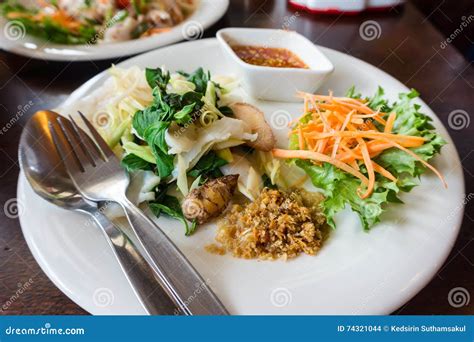 Boiled Fish Sauce with Ginger, Carrot, Lettuce, Galangal, Basil, Lemon Grass on White Dish Stock ...