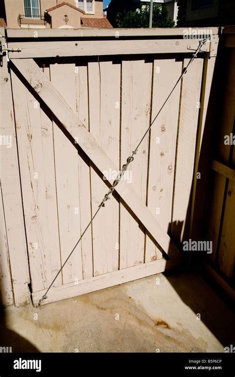 Wooden gate with wire support with turnbuckle Stock Photo - Alamy