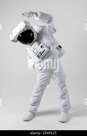 Astronaut stretching before exercise, white background Stock Photo - Alamy