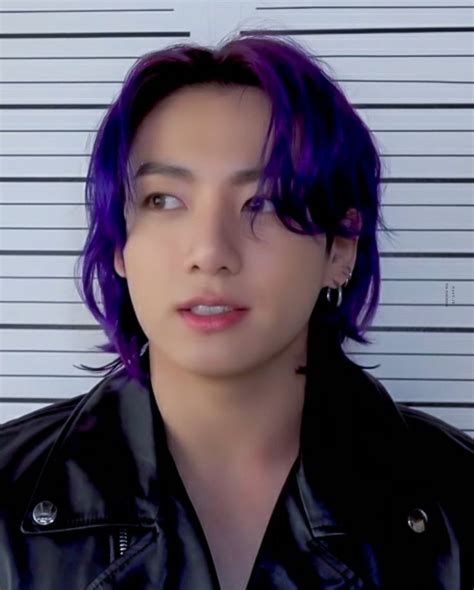 a man with purple hair wearing a black leather jacket