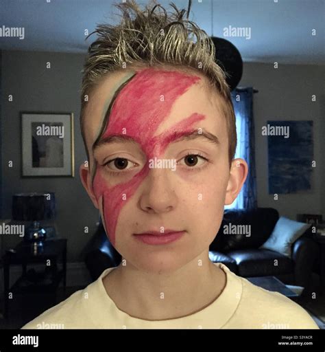 Young boy with the David Bowie Aladdin Sane album cover Lightning bolt makeup Stock Photo - Alamy