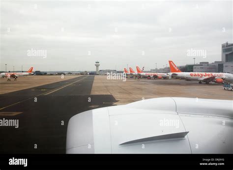 View of Gatwick Airport North terminal showing row of parked Easyjet ...