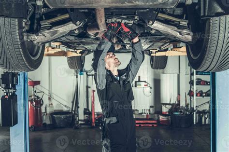 Mechanic Fixing Car on a Lift 24613867 Stock Photo at Vecteezy