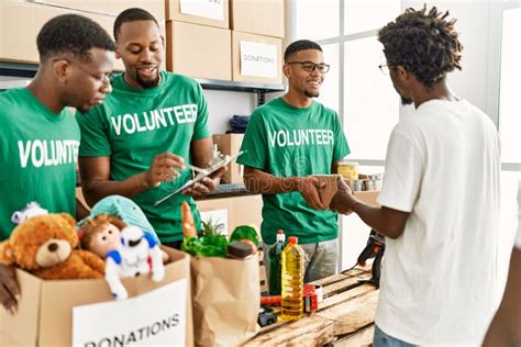 Group of Young African American Volunteers Helping People at Charity Center Stock Photo - Image ...