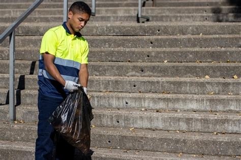 Premium Photo | Portrait of a latino male garbage collector in work uniform collecting garbage ...