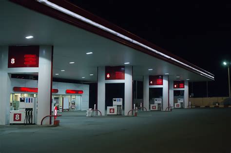 Illuminated Gas Station At Night Stock Photo - Download Image Now - iStock