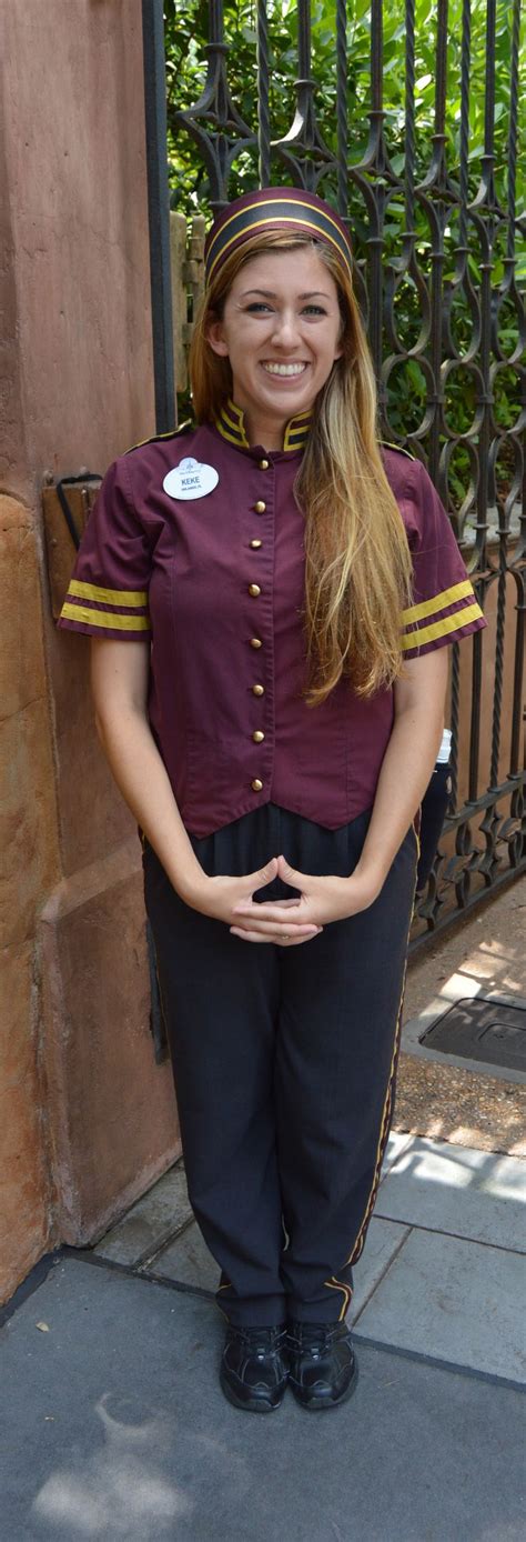 a woman in uniform standing next to a gate