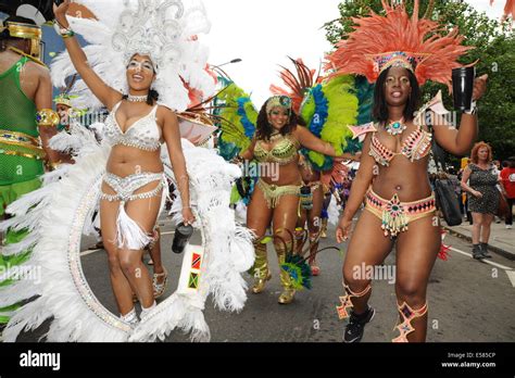 Notting hill Carnival street parade with three women wearing ...