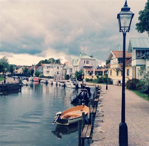 a boat is docked in the water next to a light pole and lamp post on a ...