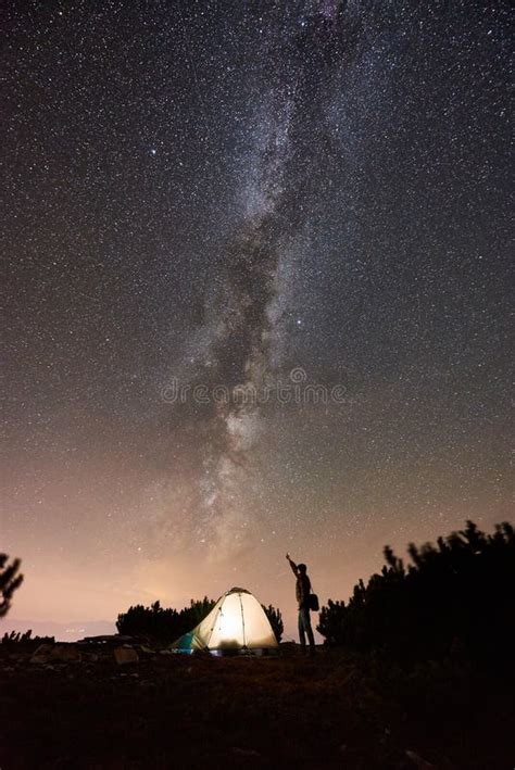 Tourist at Night Camping on Top of Mountain Under Starry Sky Stock ...