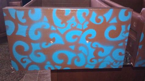 a brown and blue box with designs painted on it