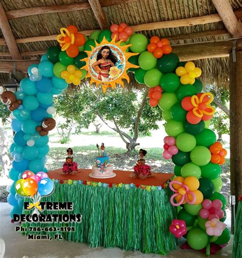 Princess Moana theme Birthday party decorations. Cake table with balloon arch with Hawaii ...