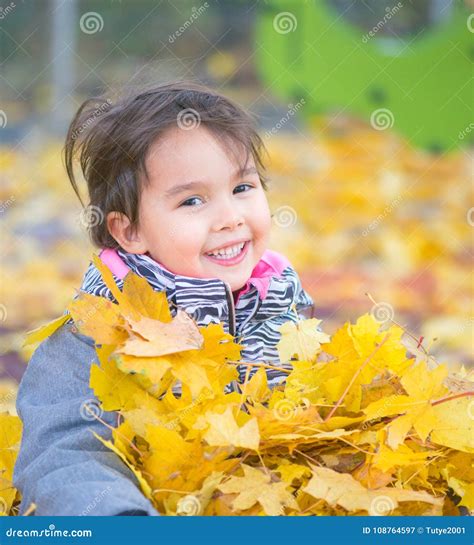 Little Girl Playing with Leaves and Smilling Stock Image - Image of ...