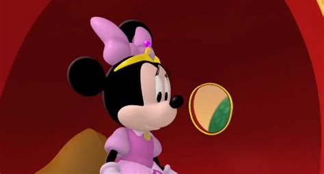 a cartoon character in a pink dress with ears on her head and an oval mirror behind her