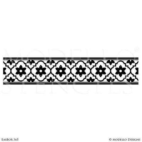 a black and white image of a decorative border, with flowers on the ...