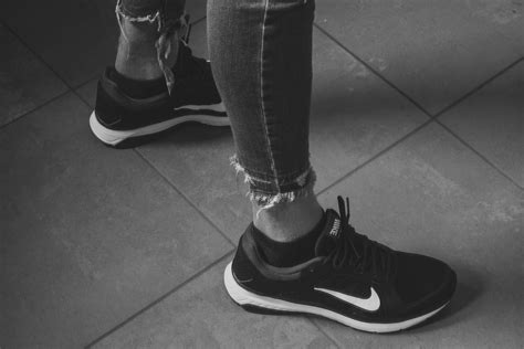 Person Wearing Gray Nike Shoes · Free Stock Photo