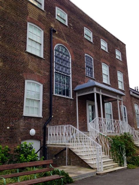 an old brick building with white stairs and windows