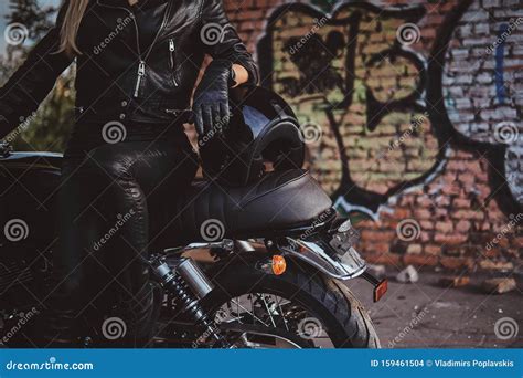 Female Biker in Black with Her Motorbike Next To Graffity Wall Stock ...