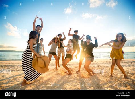 Happy young people on beach Stock Photo - Alamy