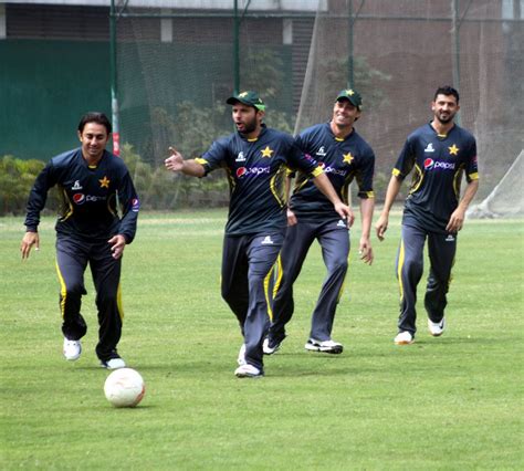 The Pakistan players kick about a football during training ...