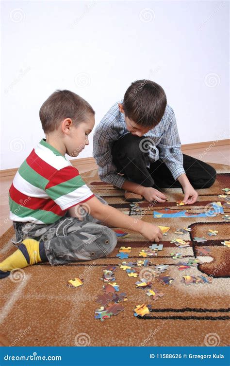 Boys playing the puzzle stock photo. Image of male, sitting - 11588626