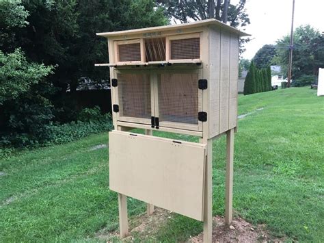 a wooden bird house with two birds in it