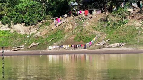 Vidéo Stock People living by the Sangu River dry their laundry on the ...