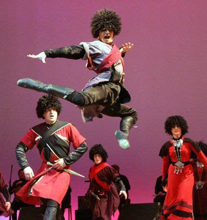 a group of people on stage with one person in the air doing a dance move