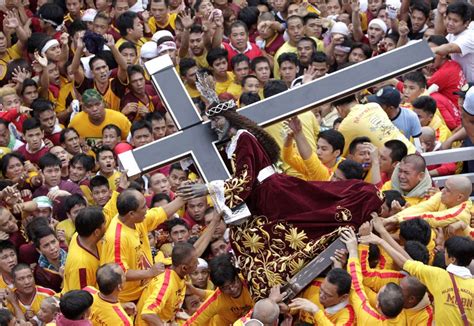 Devotees carry the statue of the Black Nazarene during the start of an annual procession in ...