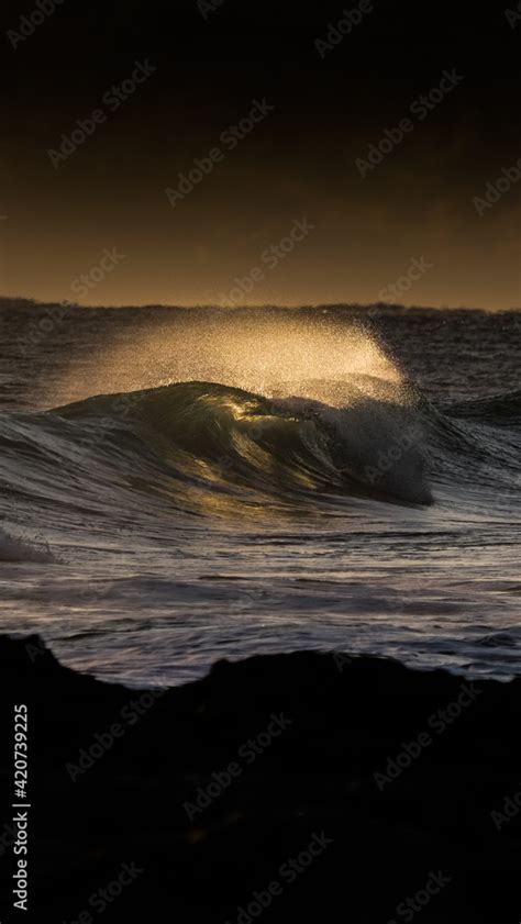 Wave during sunrise Stock Photo | Adobe Stock