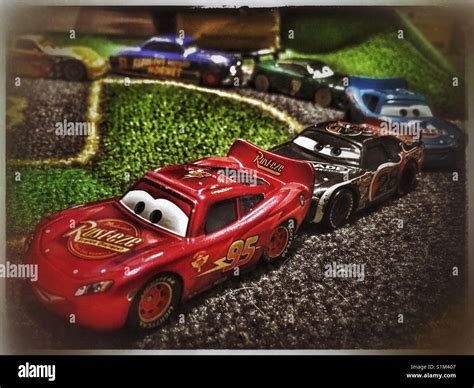 Toy Cars from The Cars Movie Franchise race on a child's race mat Stock Photo - Alamy