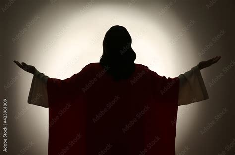 Silhouette of Jesus Christ with outstretched arms on color background, back view Stock Photo ...