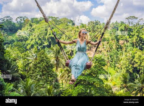 Young woman swinging in the jungle rainforest of Bali island, Indonesia ...