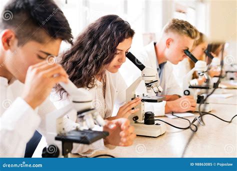 Beautiful High School Students with Microscopes in Laboratory. Stock Image - Image of attractive ...