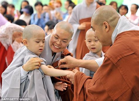 Young monks in south Korea cry as their heads are shaved for their initiation into Buddhist ...