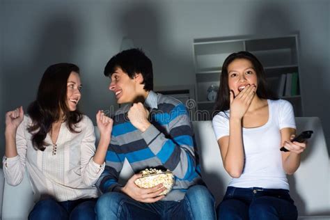 Group of Young People Watching TV on the Couch Stock Image - Image of ...